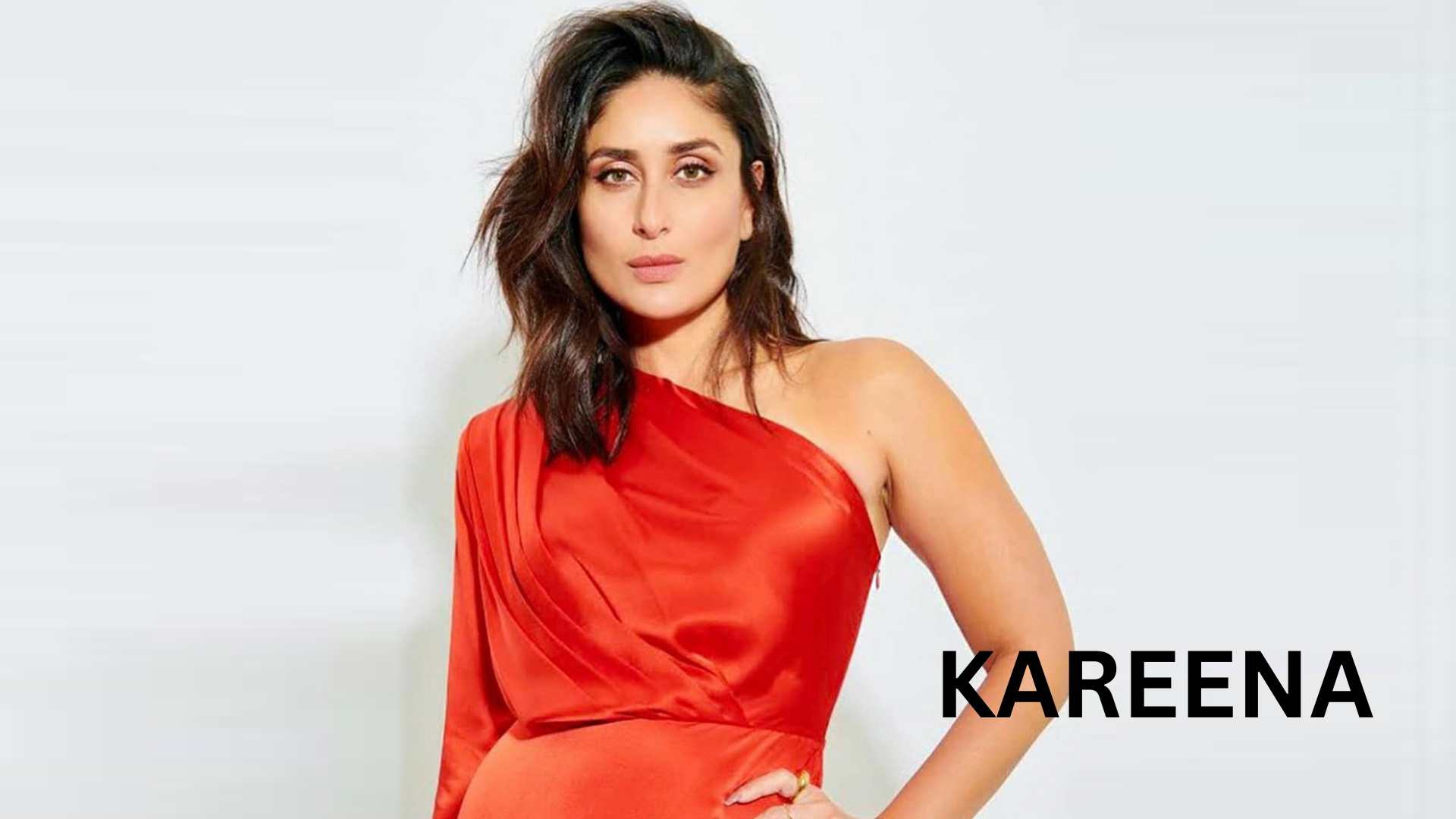 Kareena Kapoor Khan poses gracefully in a striking red outfit, exuding elegance and confidence.
