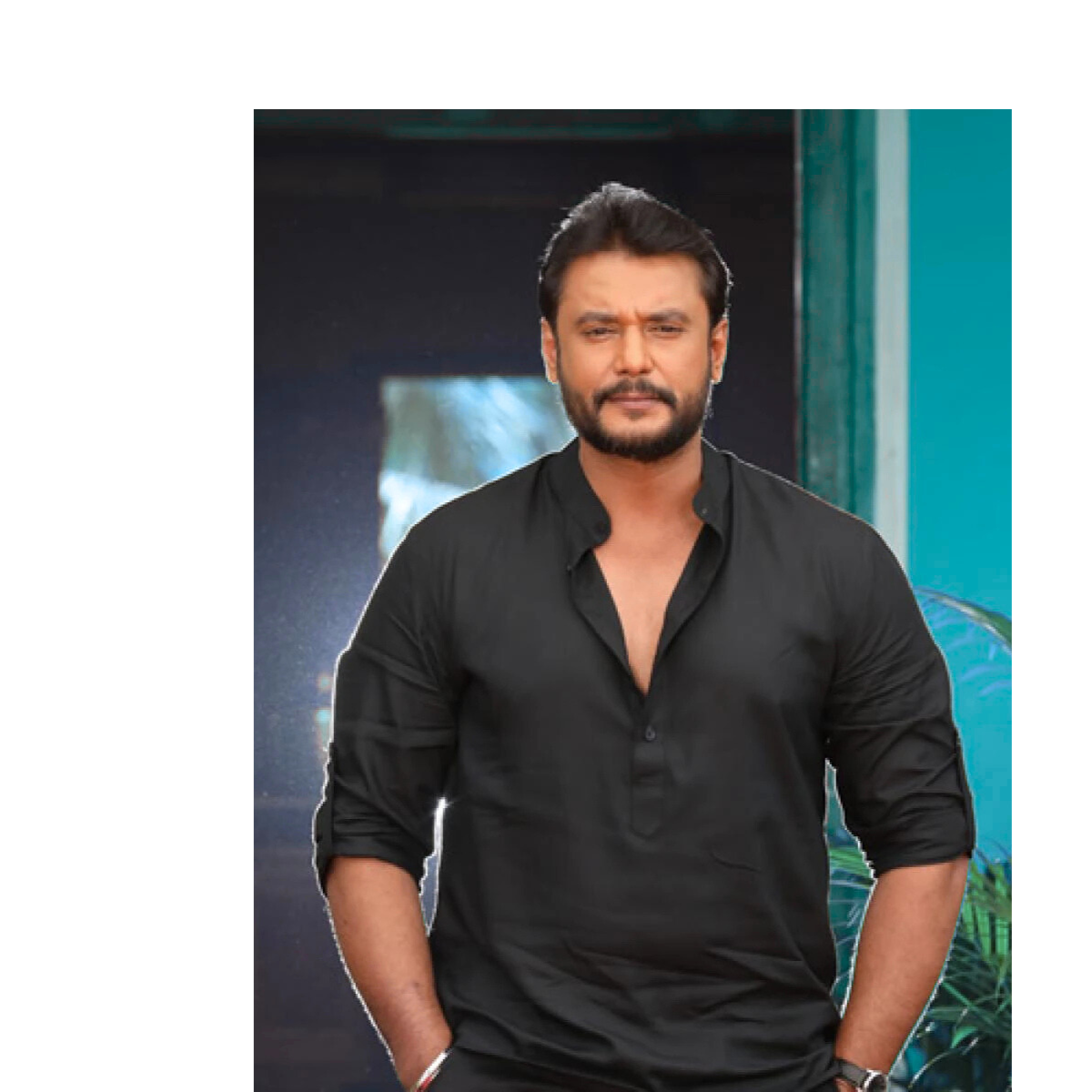 “Darshan, Kannada film actor, smiling in a portrait shot”